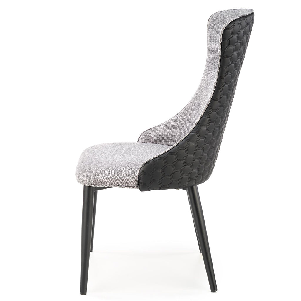 Gray and black dining chairs with fabric and faux leather upholstery and powder-coated steel legs.