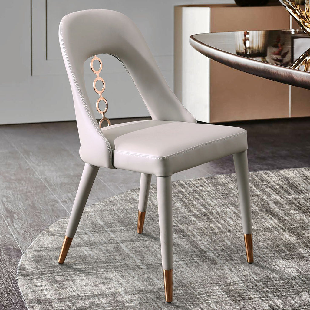 Whiteline Modern Living Liza Dining Chair set featuring sleek faux leather upholstery and detailed ornaments on the back