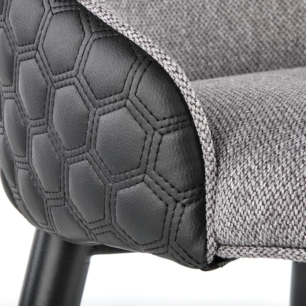 Gray and black dining chairs with fabric and faux leather upholstery and powder-coated steel legs.