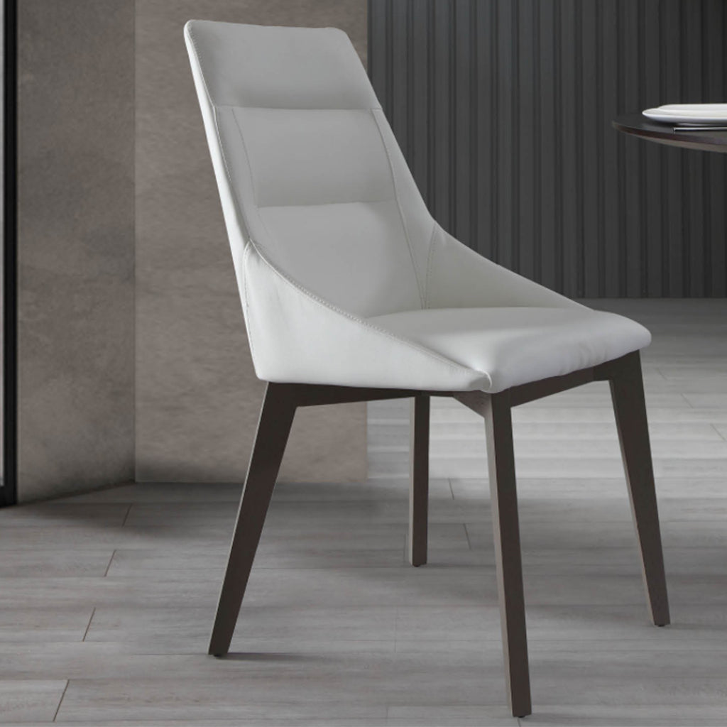 Whiteline Modern Living Siena Dining Chair featuring white faux leather upholstery and solid wood legs.