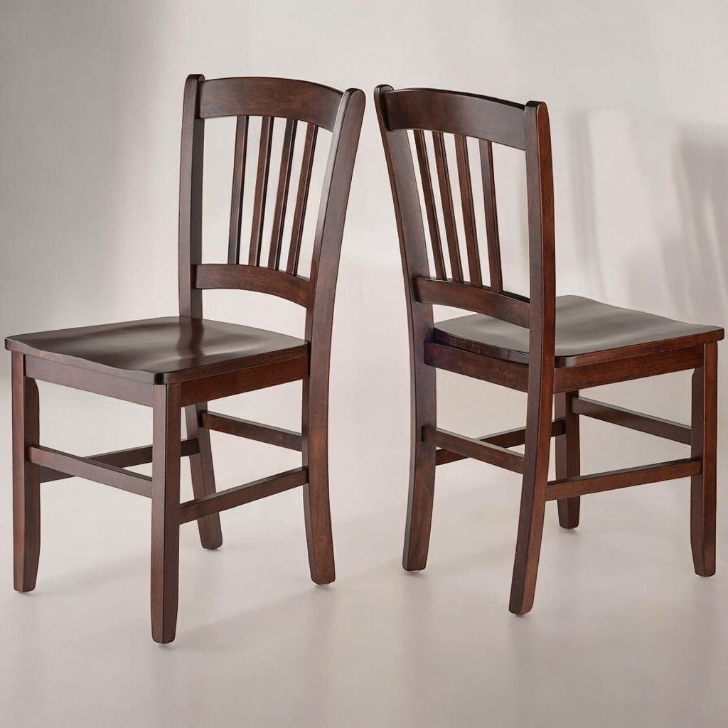 Set of two solid walnut wood dining chairs with contoured seats and gracefully curved backs, featuring a rich walnut finish.