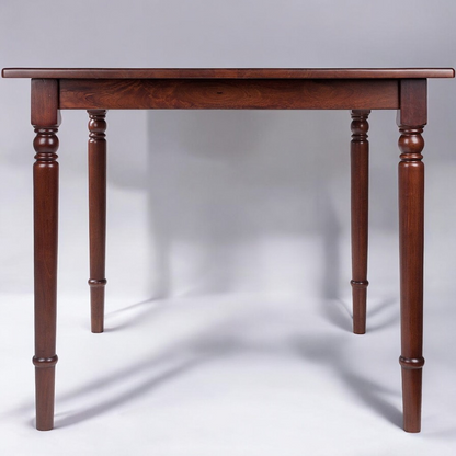 Square walnut wood dining table with turned legs and rounded corners, perfect for small dining areas.