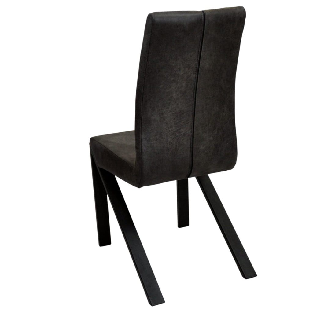 Leather lounge chairs with foam-padded seats and uniquely shaped metal legs