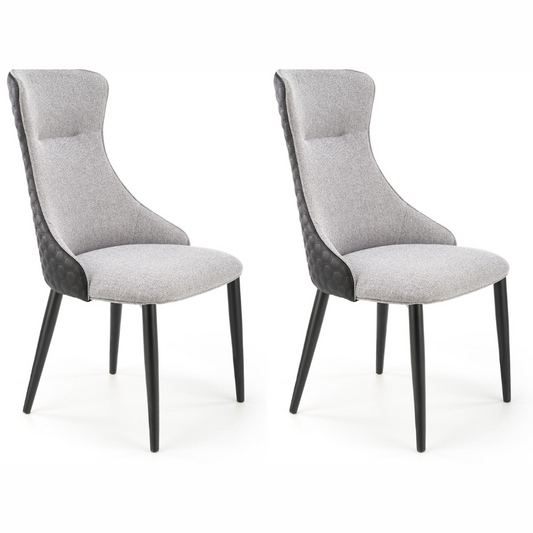 Gray and black dining chairs with fabric and faux leather upholstery and powder-coated steel legs.